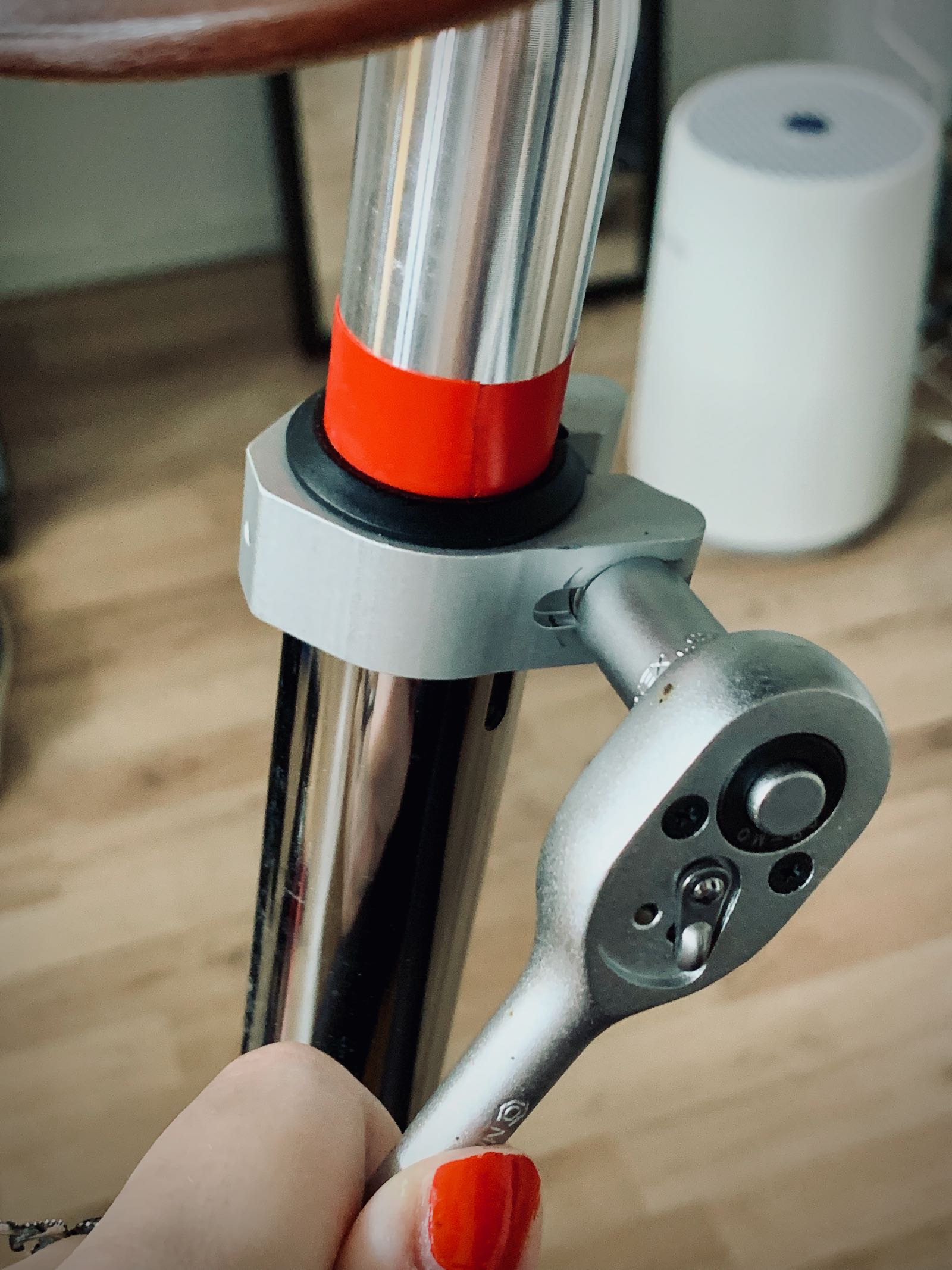 Tightnening the clamp with nut and bolt on the seatpost