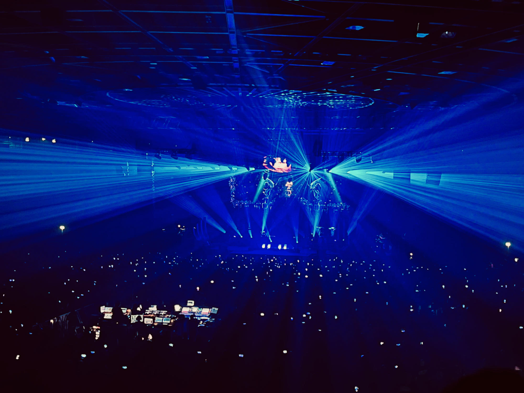 Concert stage with blue light spots shining into the audience