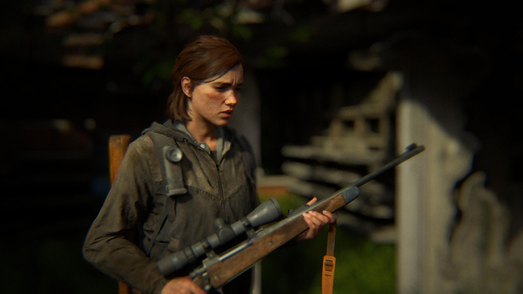 Ellie from The Last of Us Part2, holding a rifle, looking down with a sincere expression