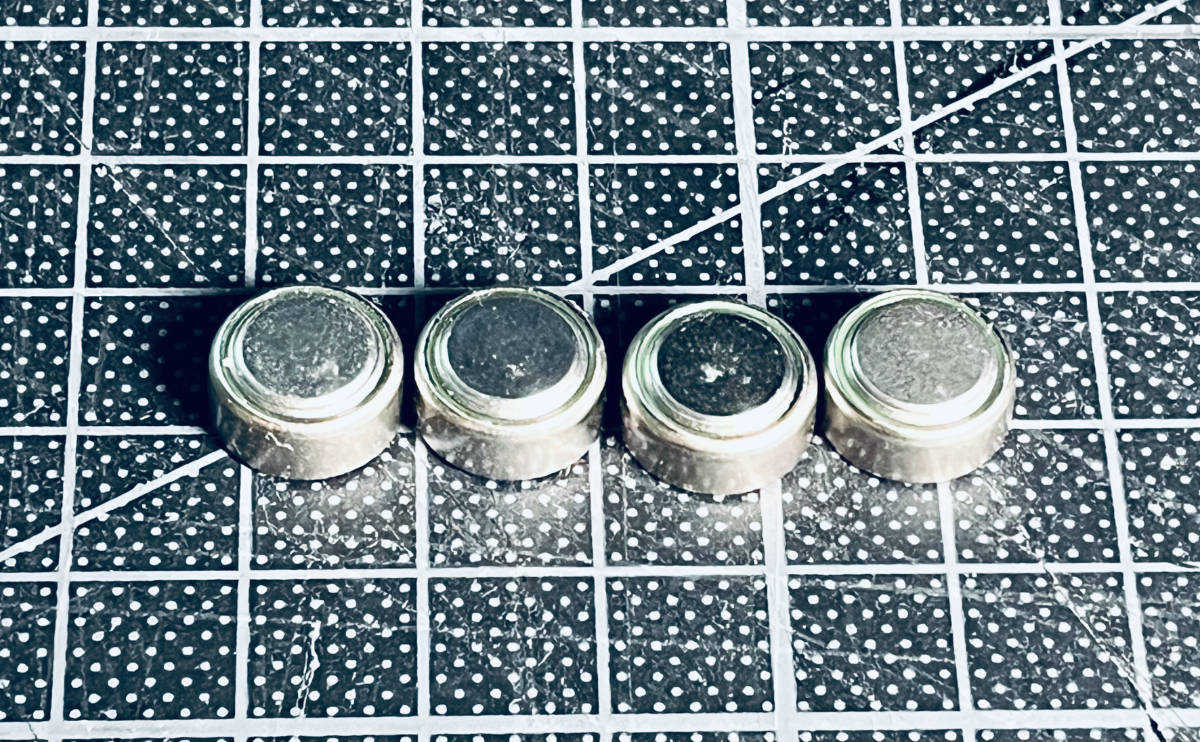 photo of 4 individual LR44 button cell batteries