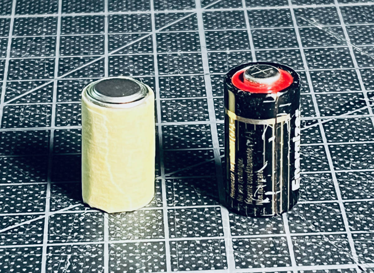 the stack of LR44s taped together with masking tape, next to the 4LR44