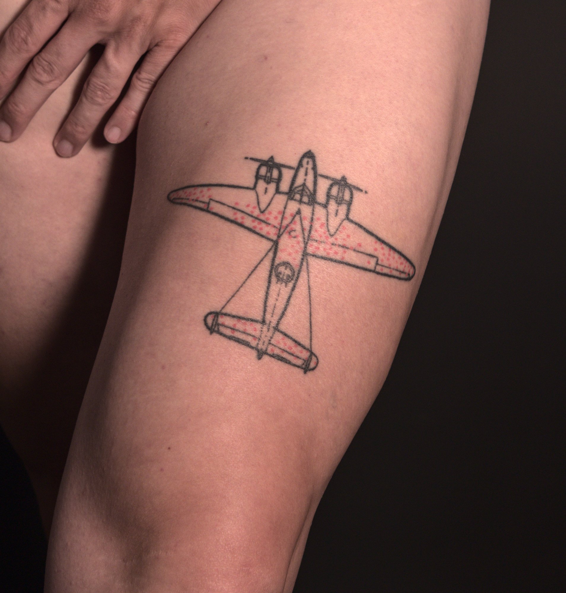 The survivorship bias airplane illustration tattooed on the front of the left thigh