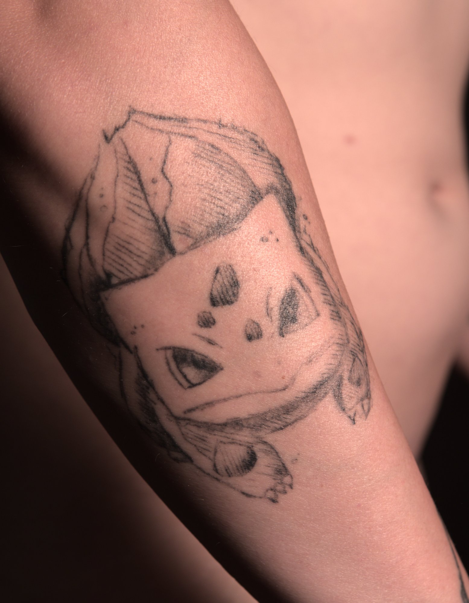 tattoo of Bulbasaur, looking angry, in a rough sketch style
